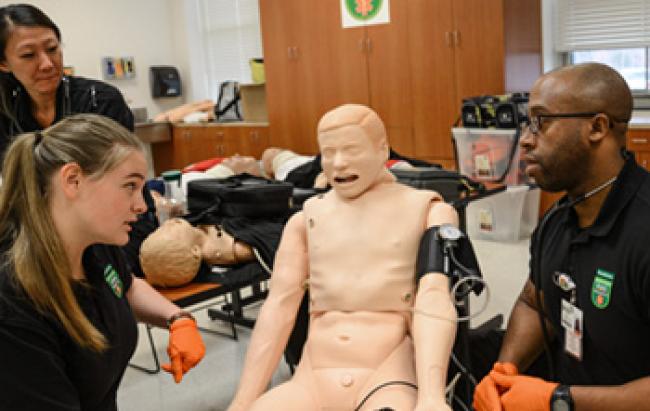 EMS Students around a test dummy